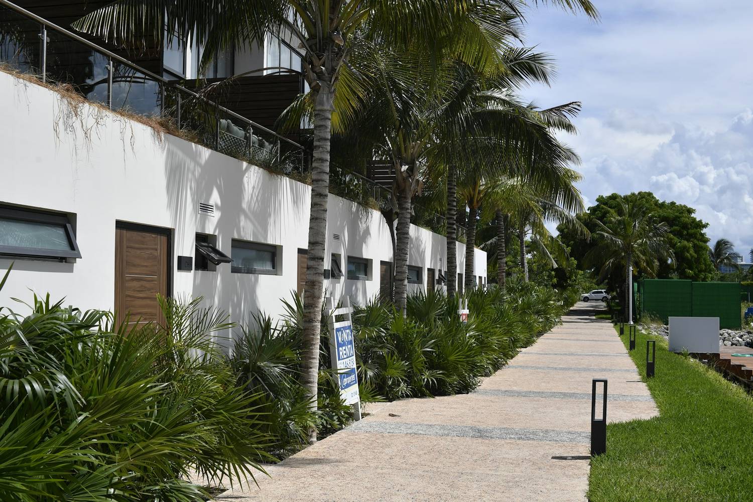 A green tropical garden path through the hotel